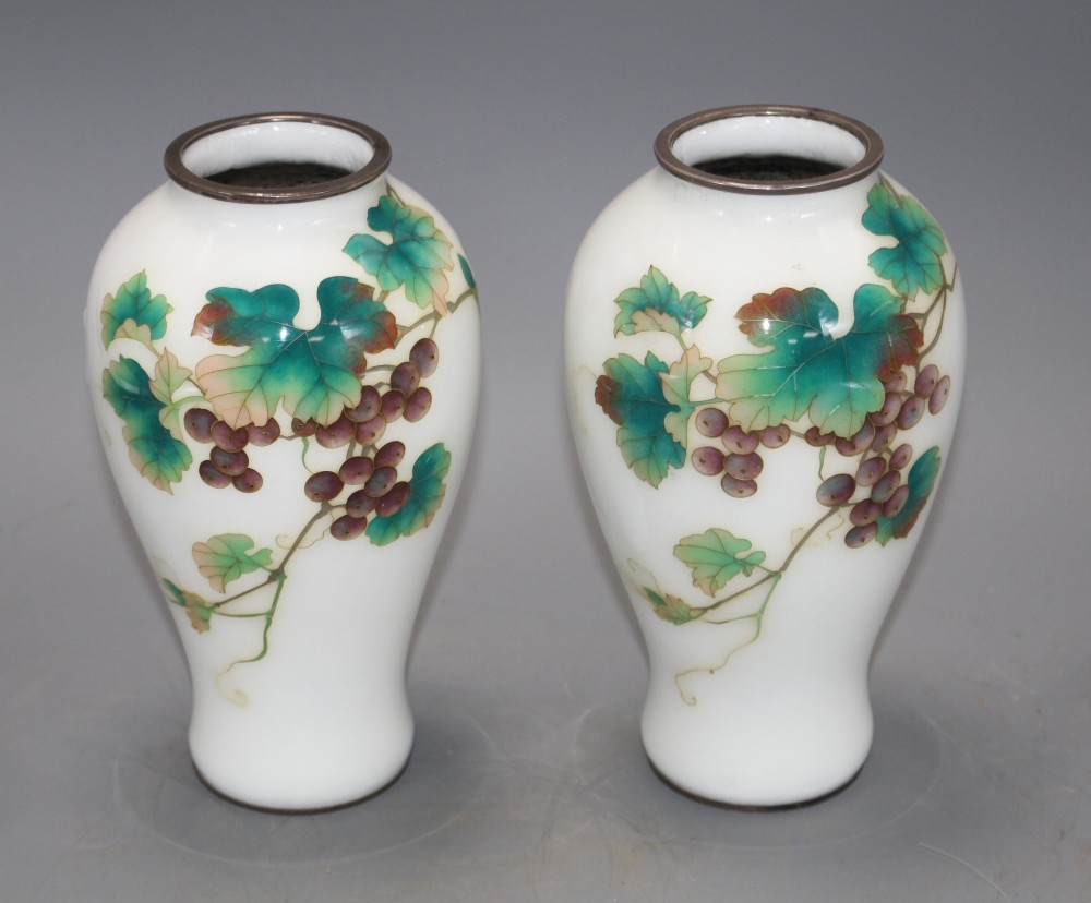A pair of Japanese cloisonne silver wire vases, decorated with grapes on a white ground, height 18.5cm